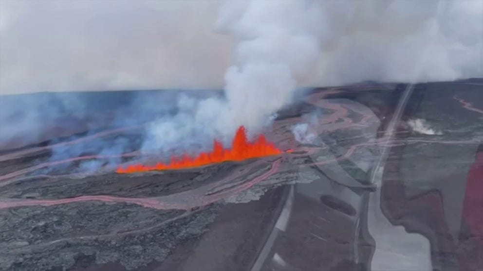 Video recorded from above Hawaii's Mauna Loa volcano shows jaw-dropping images of lava shooting from an active fissure.
