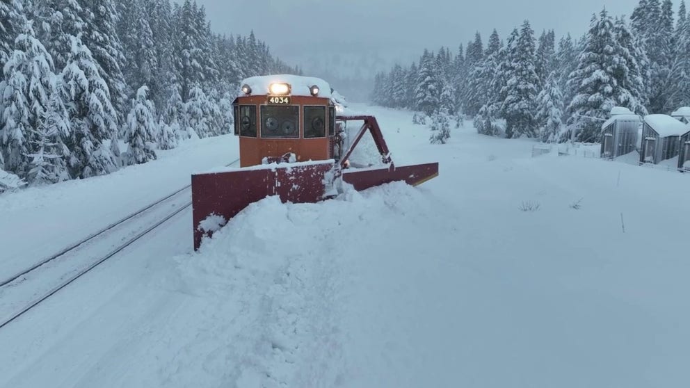 Drone video captures a train plowing snow in Donner Pass, California during a winter storm. (Credit: Brandon Clement / LSM)