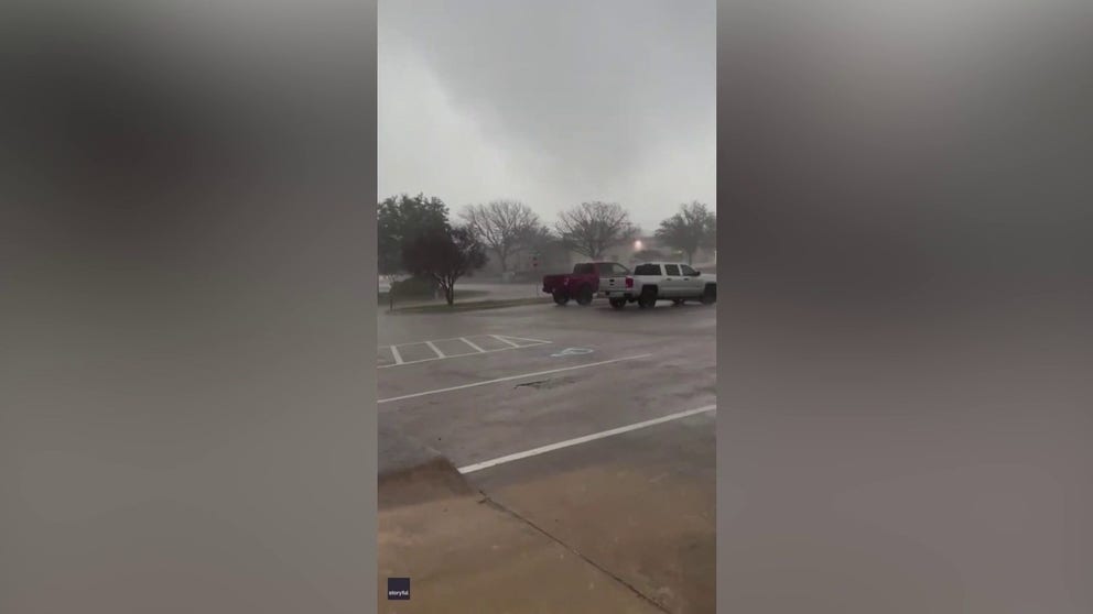  Severe storms are captured on video passing near the Dallas/Fort Worth International on Tuesday. Electrical lights are seen flashing during a tornado warning. (Credit: Brian Saling via Storyful)