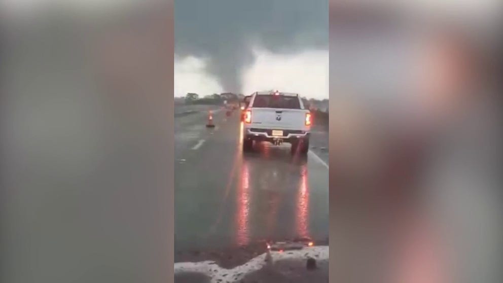 Video captures a tornado crossing a highway in New Iberia, Louisiana on Wednesday. 