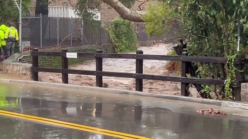 Floodwaters rush through Mission Creek in Santa Barbara, California on Monday. (Credit: @keithrbutler/Twitter)