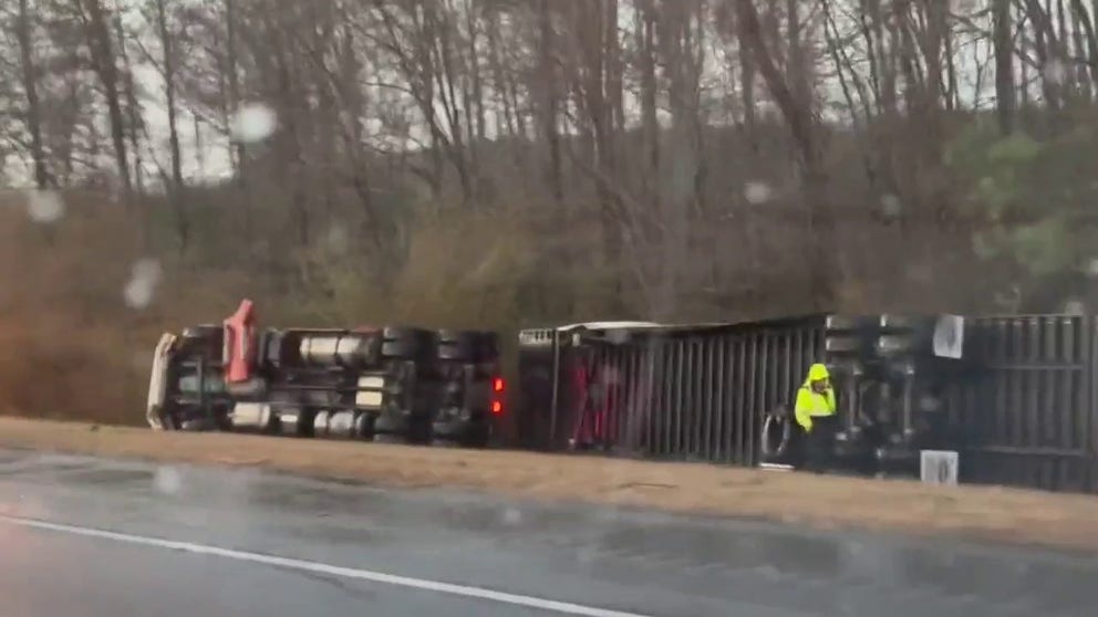 This video taken near I-85 and I-185 in LaGrange, Georgia, shows how powerful wind flattened part of the tree line and flipped a semi-truck to its side. Deadly storms swept through the South on January 12, 2023. (Courtesy: @BlueATLGeorgia / Twitter)