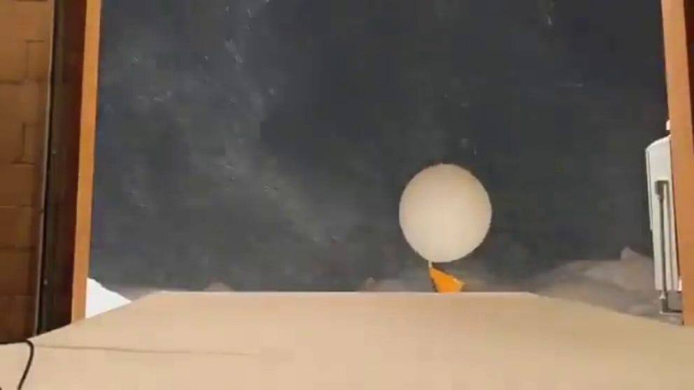 The National Weather Service in Flagstaff, Arizona, launches their morning weather balloon amidst the region's latest snow band on Friday. 