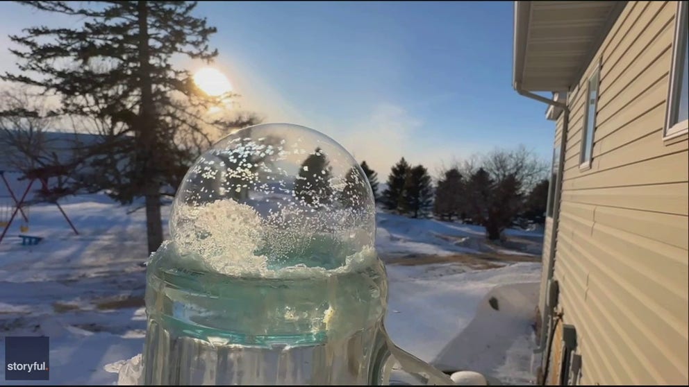 Footage recorded by Carol Bauer shows ice spreading quickly on several soap bubbles in sub-zero temperatures in Graceville, Minnesota, on Sunday. 