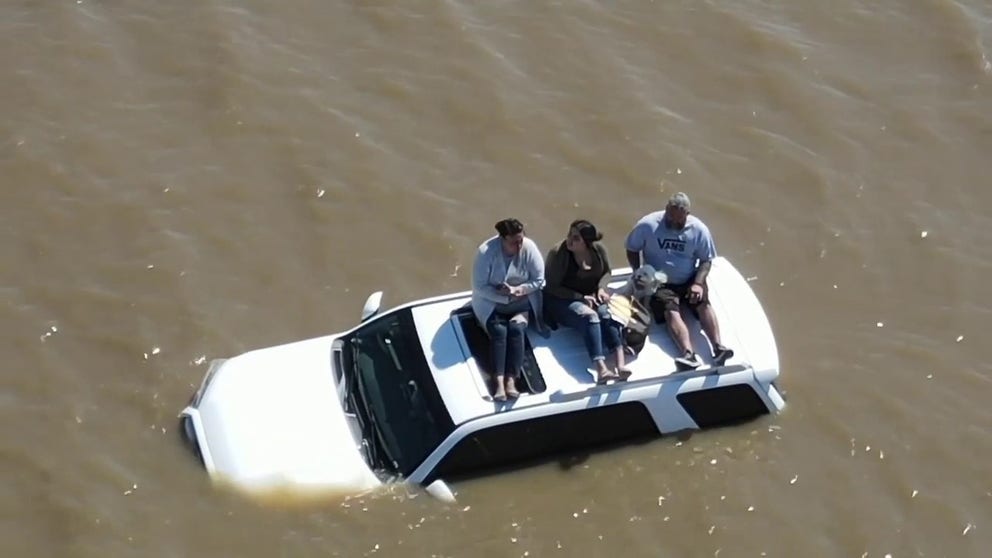 Fire crews and sheriff's deputies came to the rescue of 3 people and their dog. Watch Tulare County Sheriff's Office plane discover the group trapped on the roof of the car and swift water rescue teams take the four to safety on a boat.