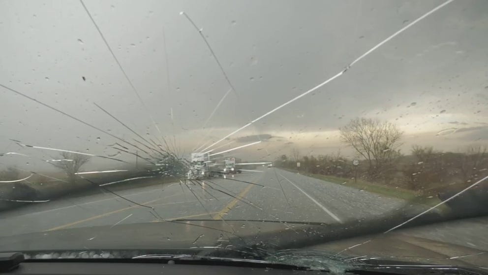 Large hail cracked storm chaser Brett Adair's windshield in Hastings, Iowa during severe storms on Wednesday. 