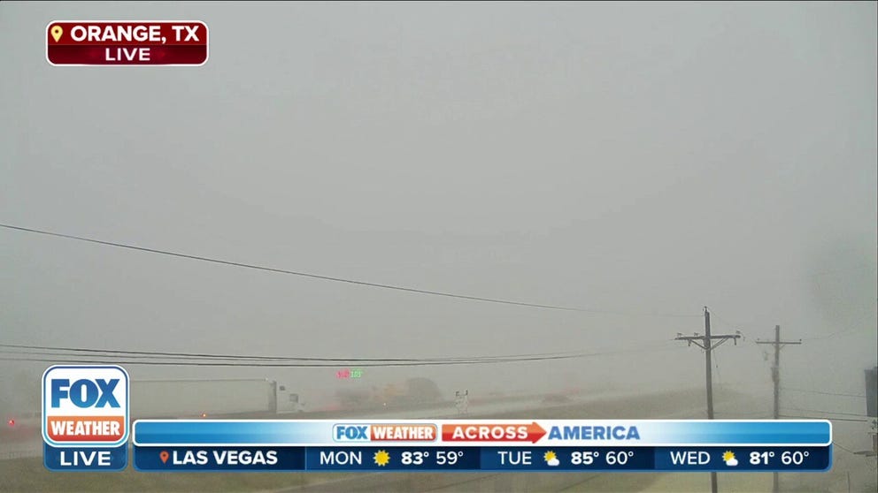 Tornado-warned storm reduces visibility while moving through Orange, Texas on Monday afternoon. 
