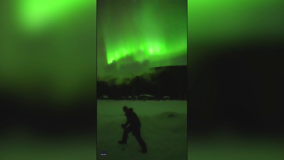 Bright green aurora in Alaska served as a magical backdrop for a fun trick involving boiling water and freezing temperatures, footage shared online shows,