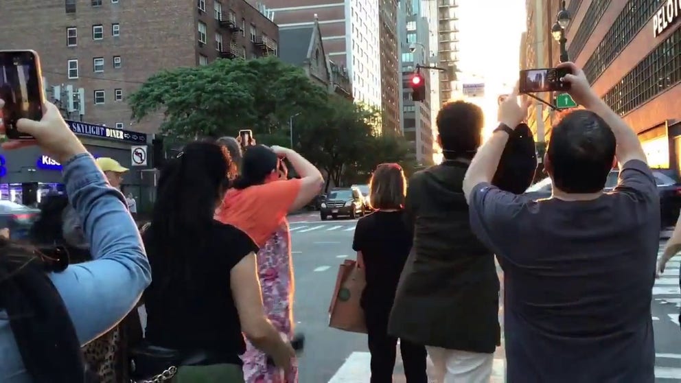 Crowds gathered Monday, May 29, to witness the first Manhattanhenge of the year. That's when the sun sets in perfect alignment with Manhattan’s east- and west-numbered streets to create cinema-worthy photo opportunities.