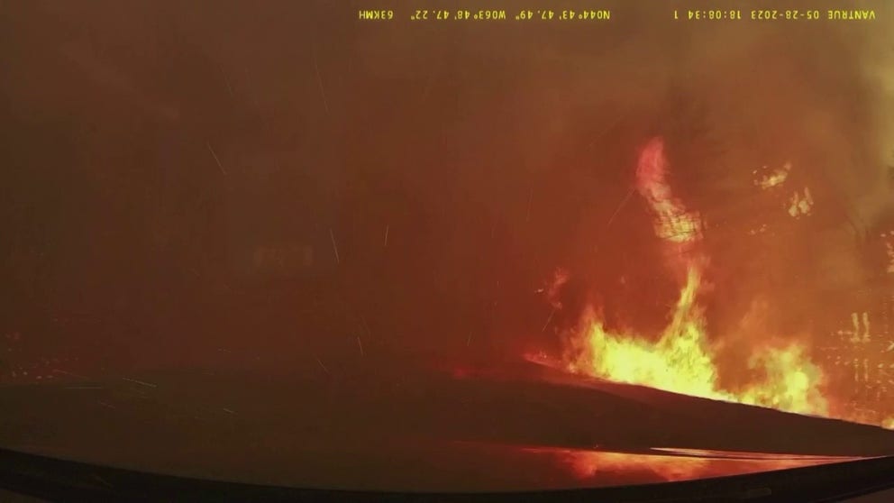Video recorded in Nova Scotia, Canada, on May 28, 2023, shows a man trying to drive through a raging wildfire in order to escape the flames. At one point in the video, his vehicle nearly slams into another that was stopped on the road but wasn't seen until the last minute due to the thick, black smoke.