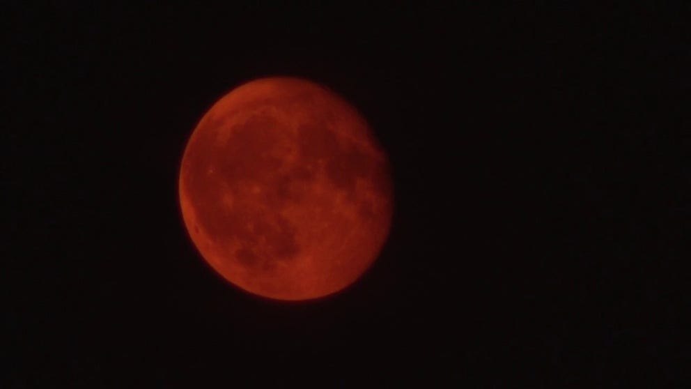 A time-lapse video shows a nearly full moon rising over Philadelphia Monday night. The moon appears in a smoky red hue because of wildfire smoke from Canada invading the skies across the Northeast.