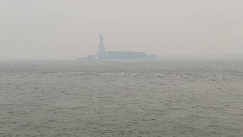 Footage captured by Paul Dousset shows wildfire smoke envelope the Statue of Liberty on Wednesday evening.