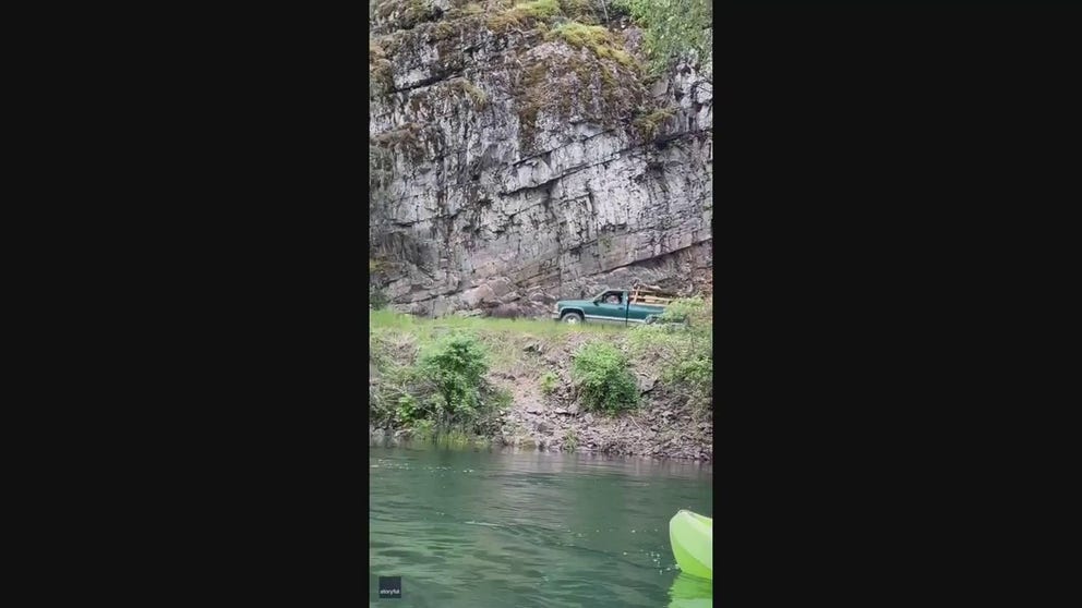 A video recorded earlier this month shows a truck chasing a terrified moose as it runs along a northern Idaho river.