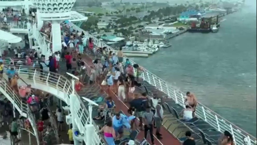 Video shows cruise passengers scrambling for safety as heavy rain and gusty winds battered Royal Caribbean's Independence of the Seas ship as it prepared to leave Port Canaveral, Florida. 
