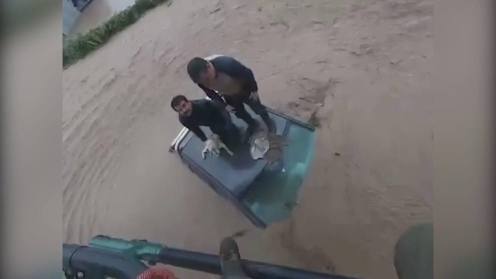 Video shows Chilean Carabineros police saving two men and one dog, who were stranded on the roof of a van as they tried to escape rising floodwaters on Friday, June 23, 2023. (Courtesy: Chilean Carabineros police via Reuters)