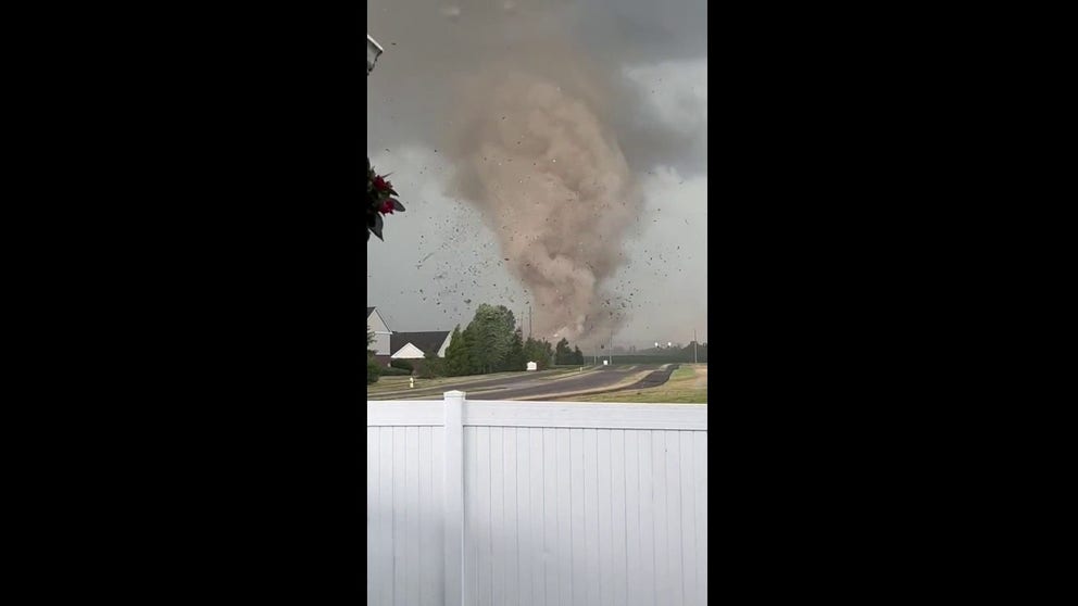 Debris is lofted into the air as a tornado rips through Greenwood, Indiana, on Sunday evening. (Video: Twitter/@EHop_13)