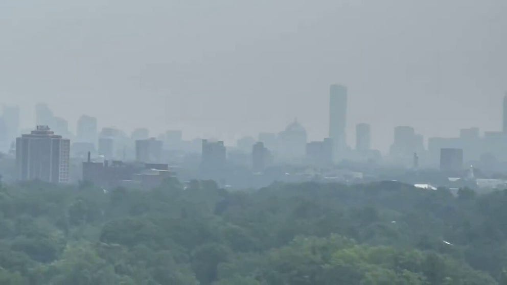 Smoke from wildfires burning in Canada billowed into Boston on Monday, and video from the area shows the skyline covered in a smoky haze.