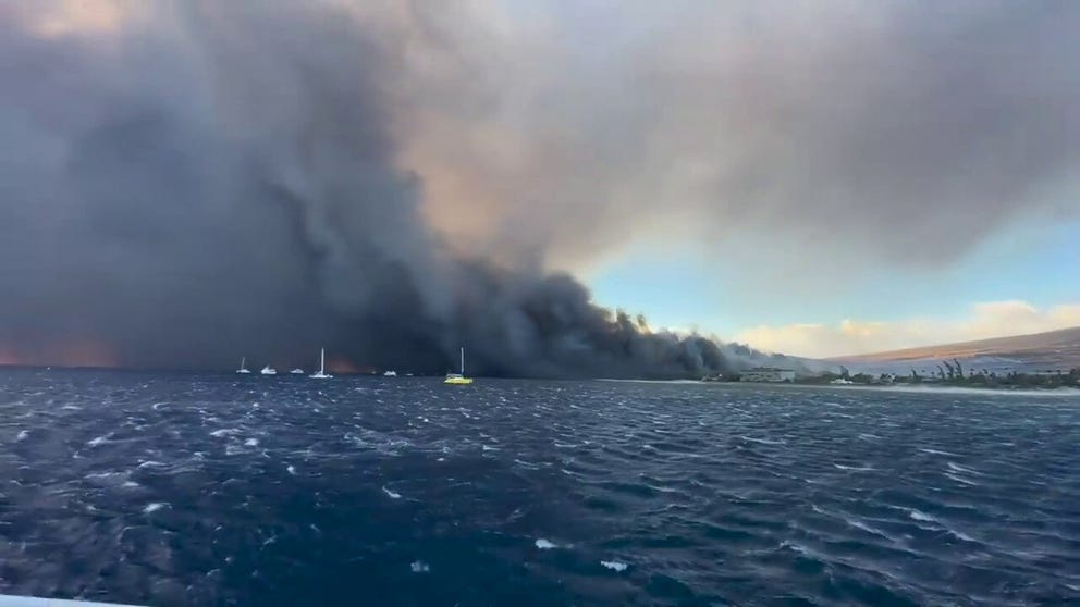 Heather Coyne recorded heartbreaking video of thick smoke billowing into the air as deadly and historic wildfires rage in Lahaina, Hawaii. 