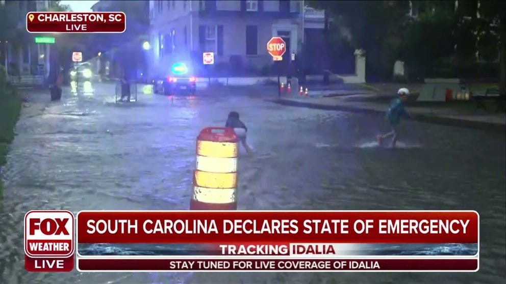 FOX Weather's Katie Byrne is knee deep in water in downtown Charleston, South Carolina. Rain and wind make it difficult for her to communicate with the FOX Weather New York Studio.