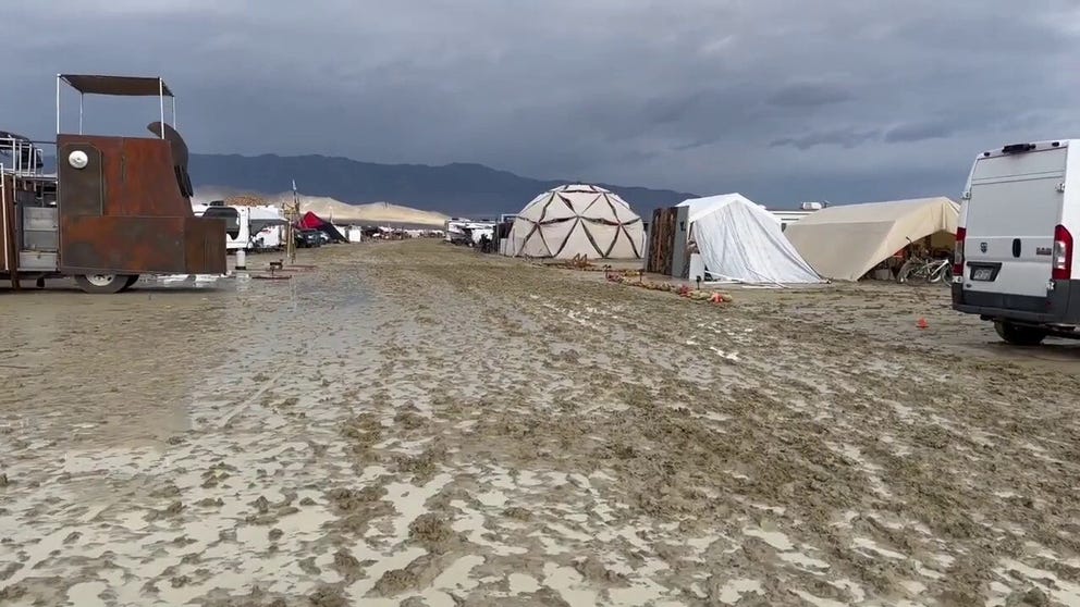 Thousands of Burning Man festival goers are stranded in Black Rock City, Nevada after monsoon rains created unsafe driving conditions on the playa.  (Video credit: Debora Domass via Storyful)