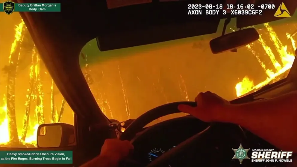 Footage shows Spokane County Deputy Brittan Morgan driving through a hellish blaze on Aug. 18 to notify residents to leave their homes as the surrounding area burned. (Courtesy: Spokane County Sheriff's Office / BODY CAMS+ /TMX)