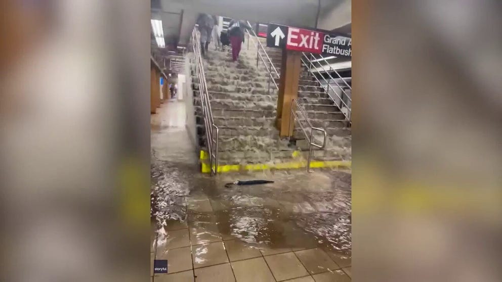 Floodwaters cascaded down stairs in a Brooklyn subway station as torrential downpours hit New York on Friday, September 29.