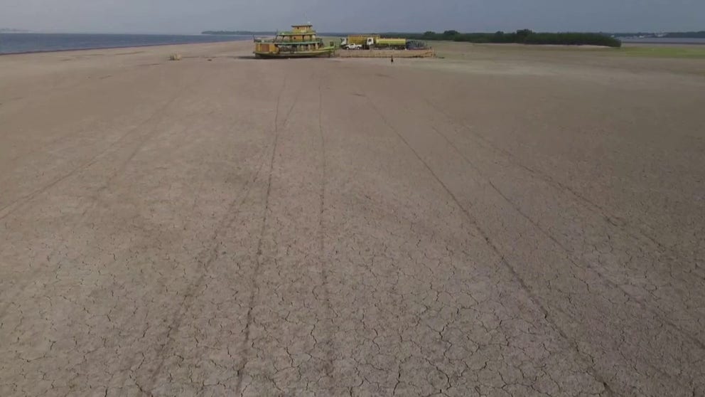 Drone video shows the extreme drought conditions on the Amazon River causing ships and cargo to become stranded. 