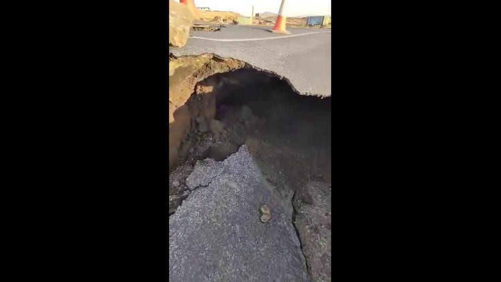 Video recorded outside Grindavik in Iceland show large cracks that formed across a road amid fears that a volcanic eruption may be imminent.