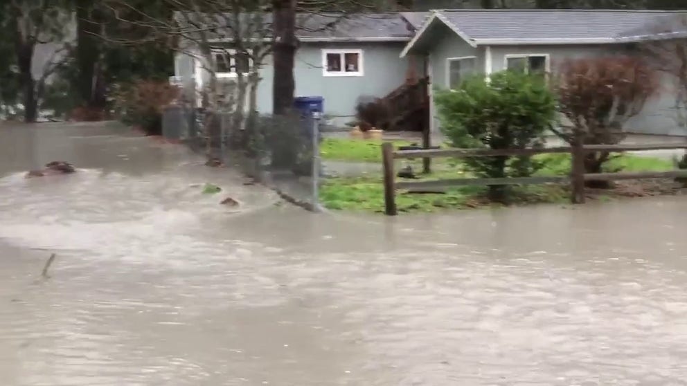 Video recorded in Granite Falls, Washington, shows the Stillaguamish River overflowing its banks and starting to flood roads and homes in the area.