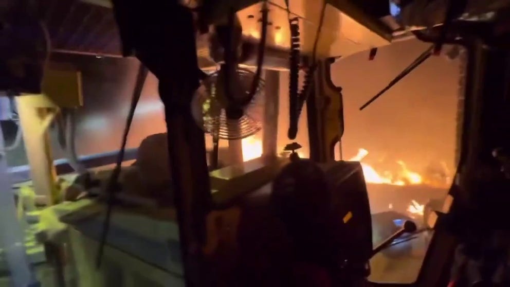 The driver of a bulldozer took video of the machine cutting containment lines overnight in the burning hills.