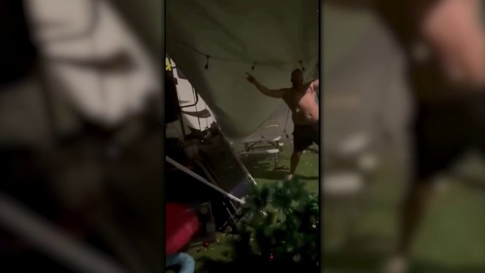 A man tried to save his camper's awning during wind gusts in eastern Australia over the Christmas holiday. 