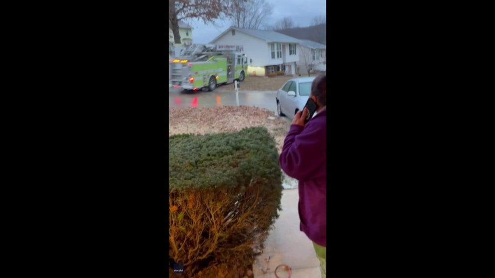 A neighbor screams in shock as she watches a firetruck lose control on an icy road in Imperial, Missouri. The truck does a 270 degree spin before you can hear it hit something off screen.