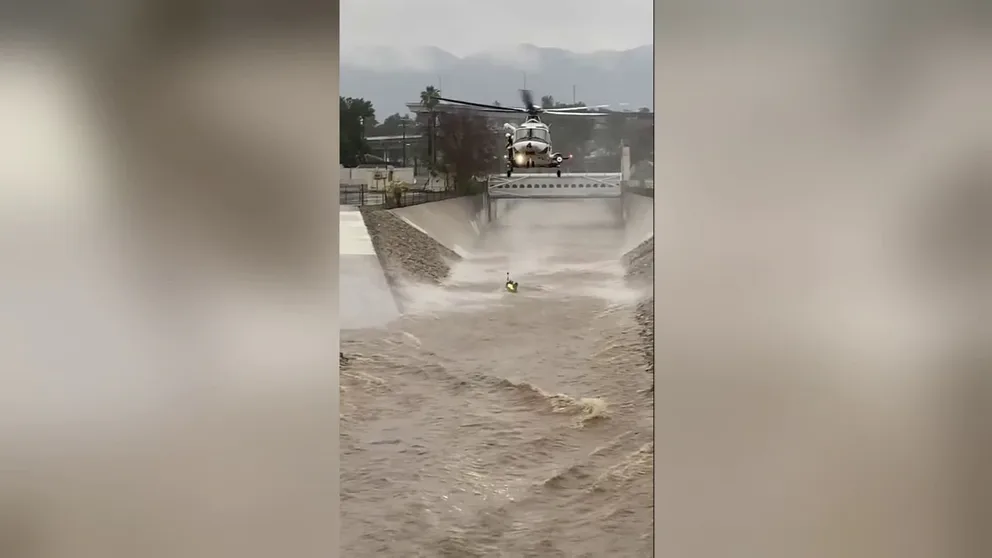 The Los Angeles Fire Department shared dramatic video of a man being rescued from a raging Los Angeles River after he jumped in to save his dog.