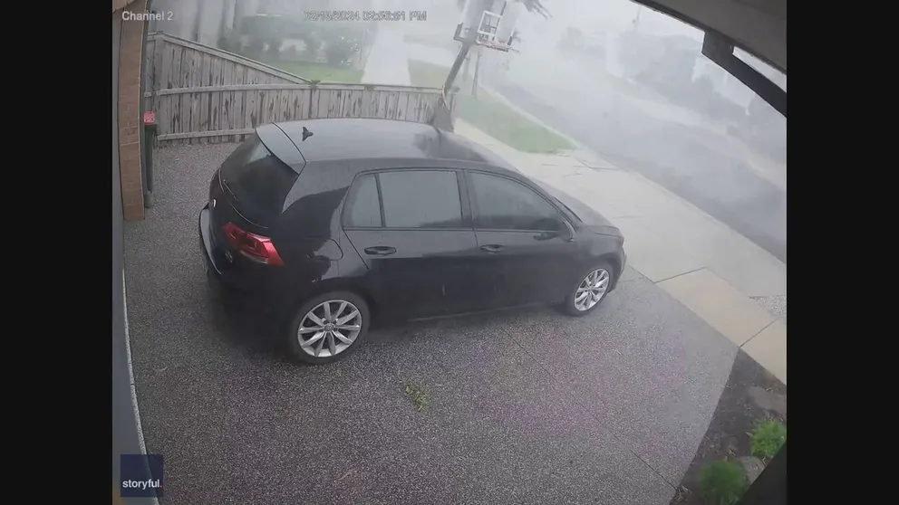 A camera in Melbourne, Australia, caught the moment powerful winds pushed a basketball goal down the driveway.
