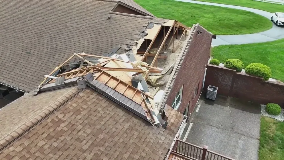 Drone video shows extensive roof damage to a home in Georgetown, Indiana on Tuesday from a potential tornado. Storm chasers also caught more video of an apparent tornado nearby.
