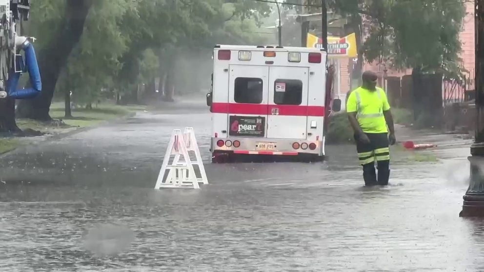First responders are seen blocking roads as water rises amid a Flash Flood Emergency in New Orleans on Wednesday morning.