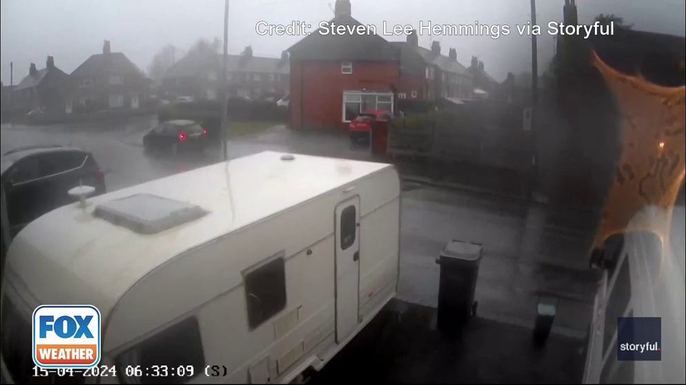 A home security camera caught what homeowners are calling a "freak" wind that flipped a camper in Knutton, England.