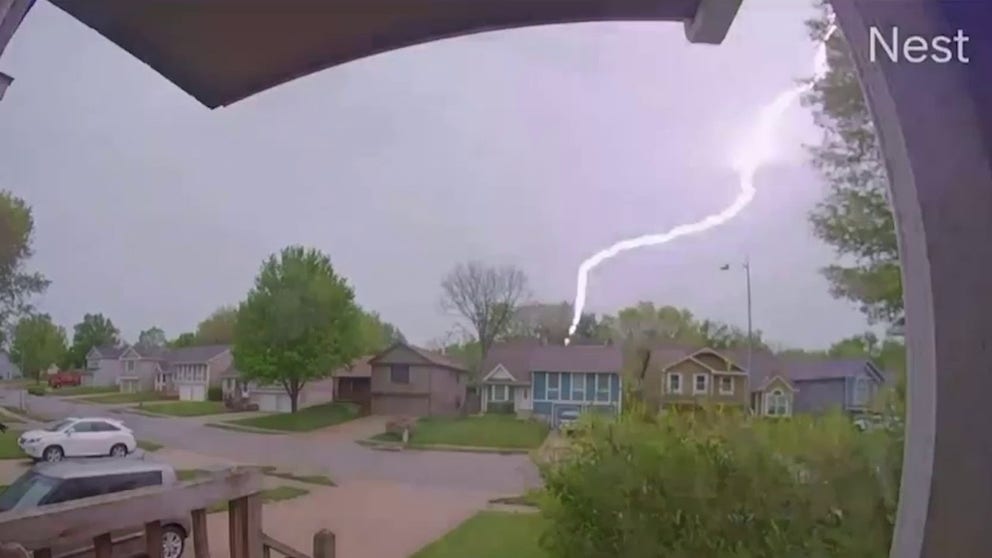 A bolt of lightning struck near a house across the street from Jordan Frederick's residence in Kansas City, Missouri, as captured by his doorbell camera on Thursday.
