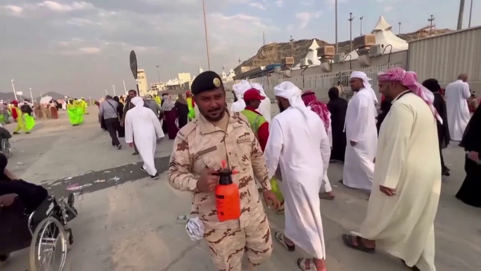 Muslim pilgrims in required clothing walk through Mina, Saudi Arabia in oppressive heat as government authorities spray people down with water during the country's annual Hajj. The Minister of Health announced that 1,301 pilgrims have died so far.
