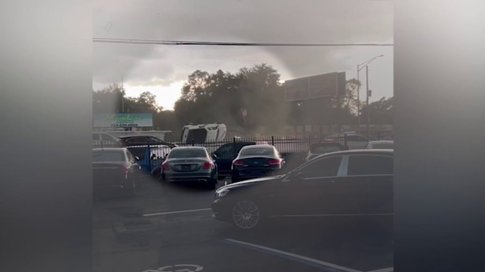 An eyewitness caught a tornado picking up a pickup truck from a Jacksonville dealership and roll it into the street.