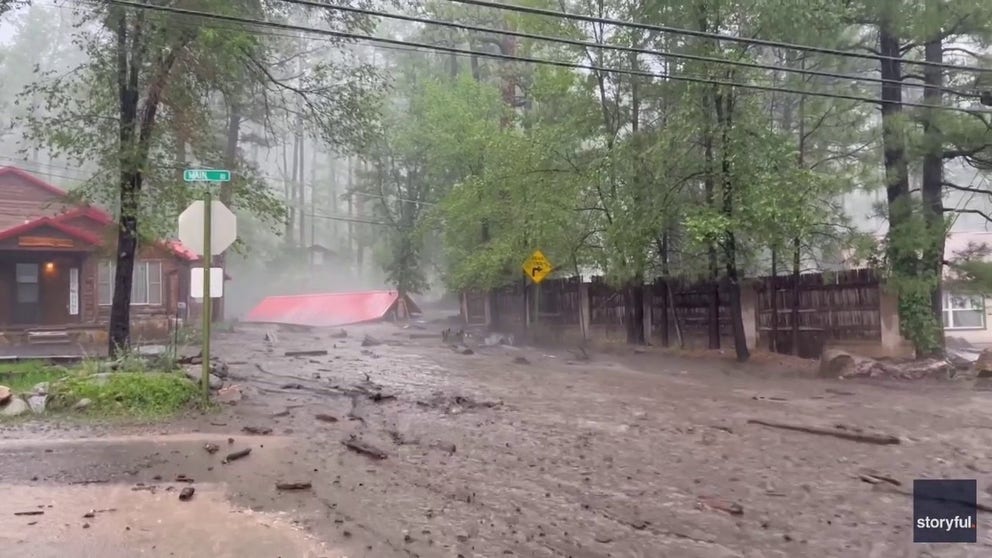 Video taken by Bjorn Adolpho shows flash flooding carrying away a garage in Ruidoso, New Mexico on July 9. 