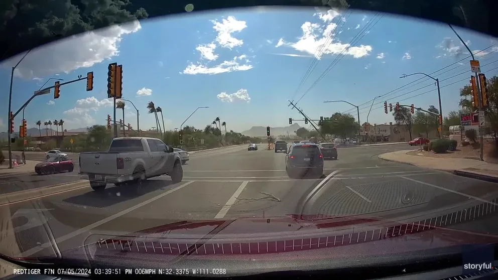 Dashcam footage shows powerful winds bringing down the power lines along a Tucson street on July 5. 