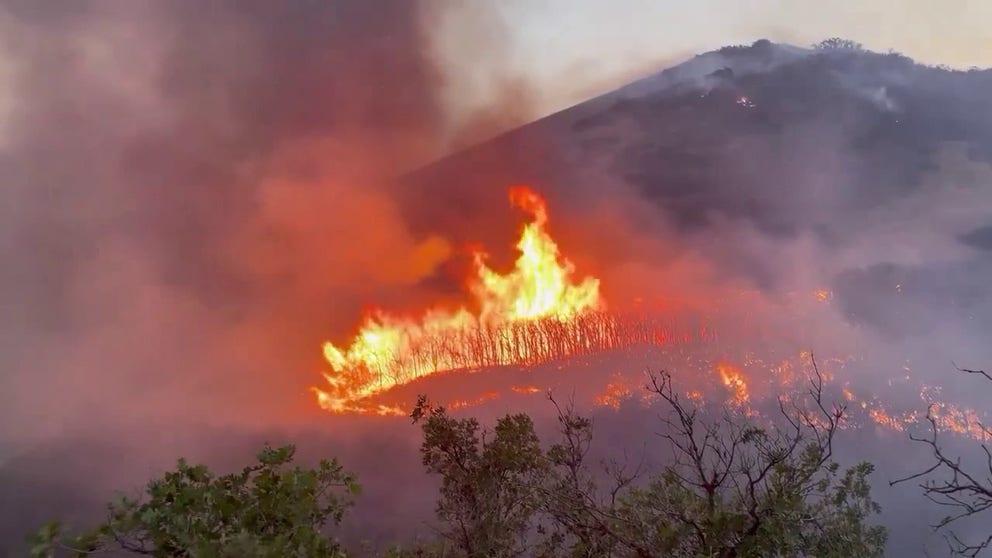 Video recorded near Salt Lake City shows flames from the Sandhurst Fire shooting into the sky on Saturday, July 20, 2024. Several homes have been evacuated in the area because of the fire.
