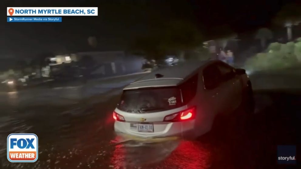 A vehicle was left stranded in floodwaters in North Myrtle Beach, South Carolina, as heavy rain from Storm Debby lashed the region on Tuesday. Footage captured by StormRunner Media shows a car stranded in floodwaters along North Ocean Boulevard as rain continues to fall.