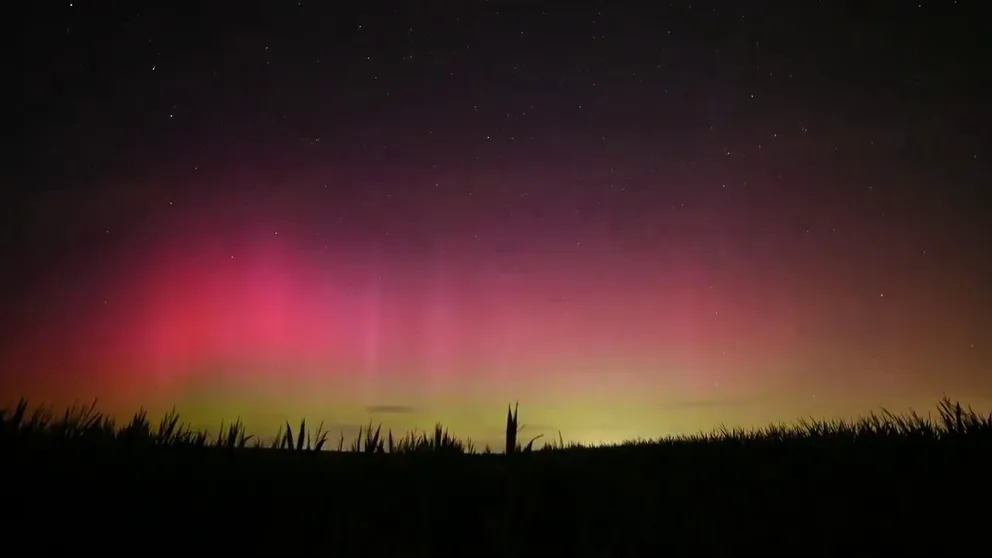 Video capture by Landon Moeller in Franklin Grove, Illinois, shows bright pink, yellow, and green aurora lights dancing above the grasslands. The lights were created by a strong geomagnetic storm. 