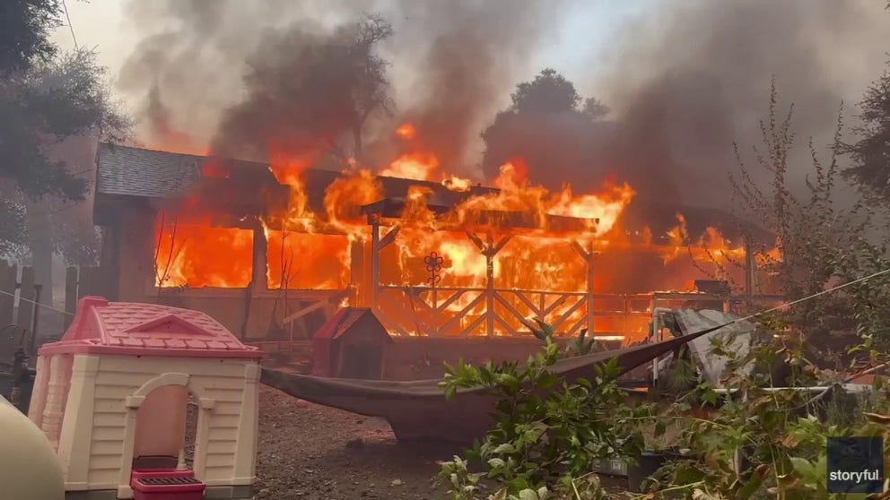 Video from Christoper Paetow shows flames from the Airport Fire burning a home in Decker Canyon, California on Tuesday.