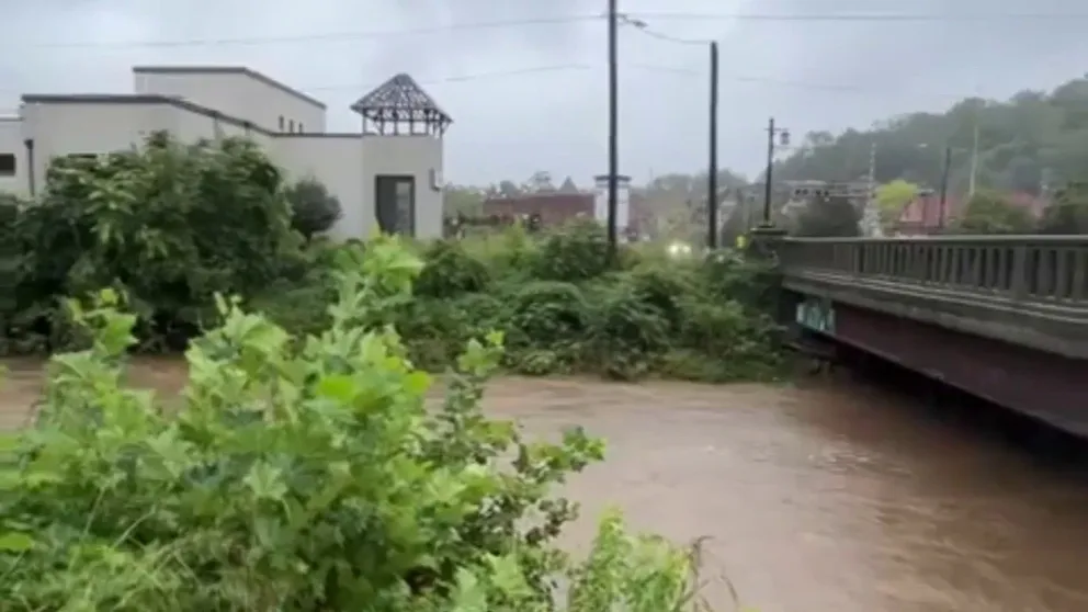 Flooding from heavy rainfall caused the Swannanoa River near the historic Biltmore Village to rapidly rise.