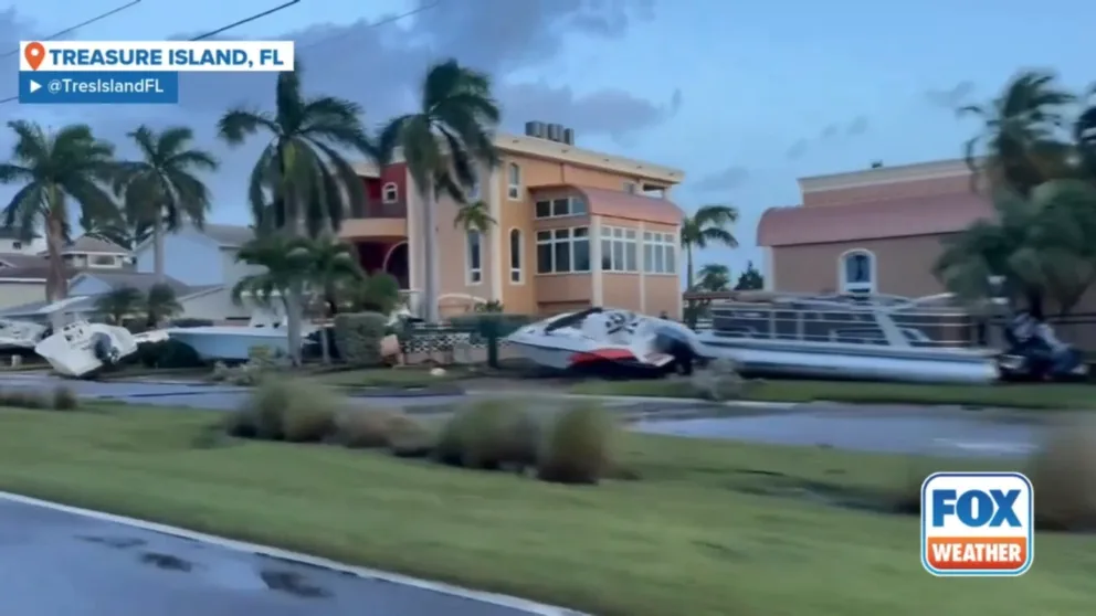 Boats were seen littered along a street in Treasure Island, Florida, early on Friday, as the community began to deal with what the local mayor called 