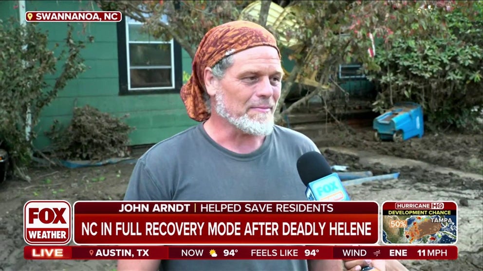 John Arndt grabbed kayaks and helped pluck people from rooftops and help break through rooftops with an axe to free people trapped in their attics.