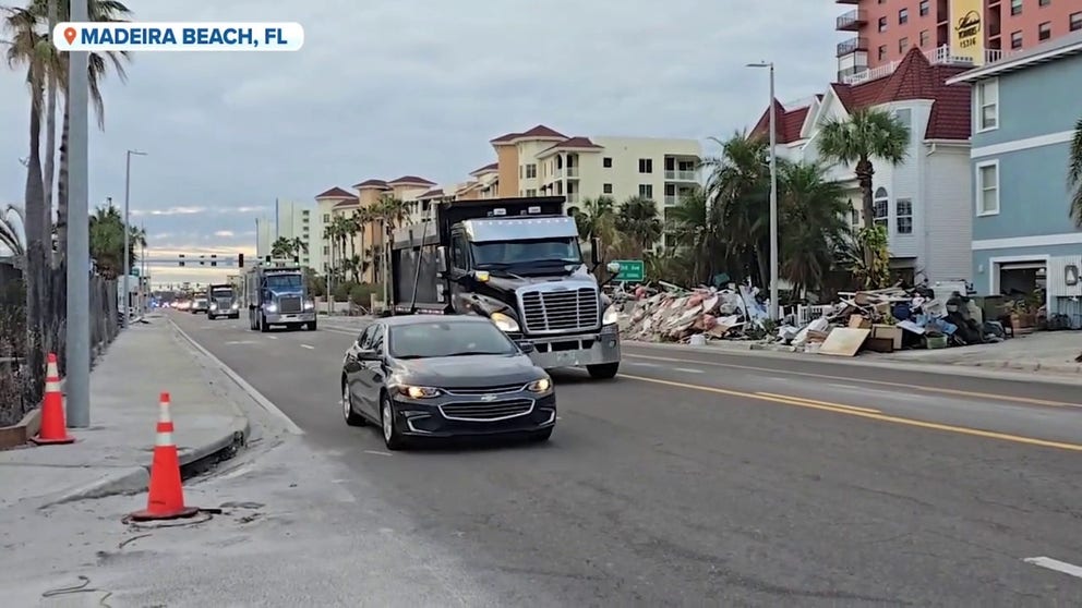 FOX Weather Storm Specialist Mike Seidel recorded video of police vehicles escorting trucks filled with storm debris left behind after Hurricane Helene in Madeira Beach, Florida, as preparations coninue ahead of Hurricane Milton.